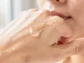 Gota de serum de vitamina C sobre la mano, mostrando para que sirve la vitamina c serum: hidratación y luminosidad.