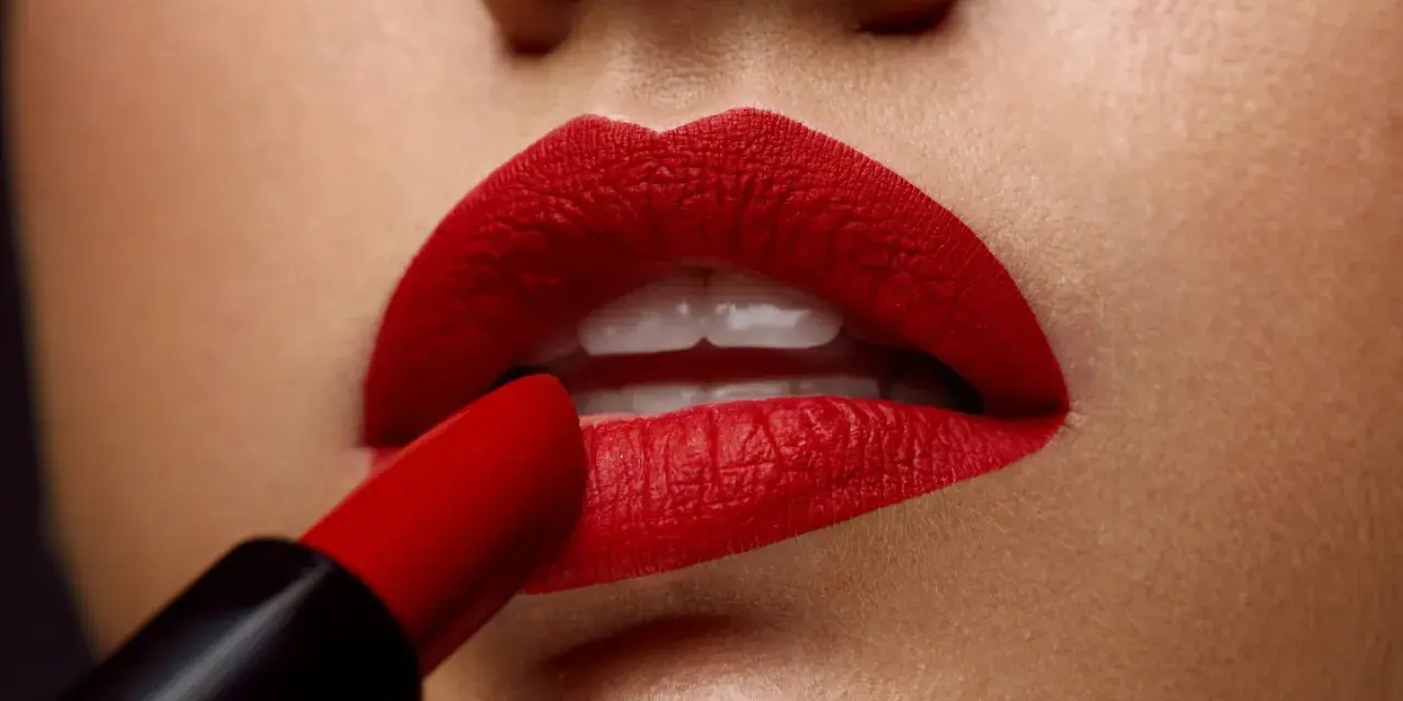 Labios perfectamente definidos con un intenso maquillaje de labios rojos, aplicados con un labial carmesí.