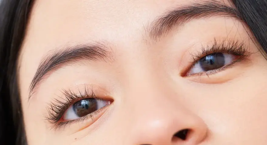 Ojos marcados con pestañas largas y cejas definidas.